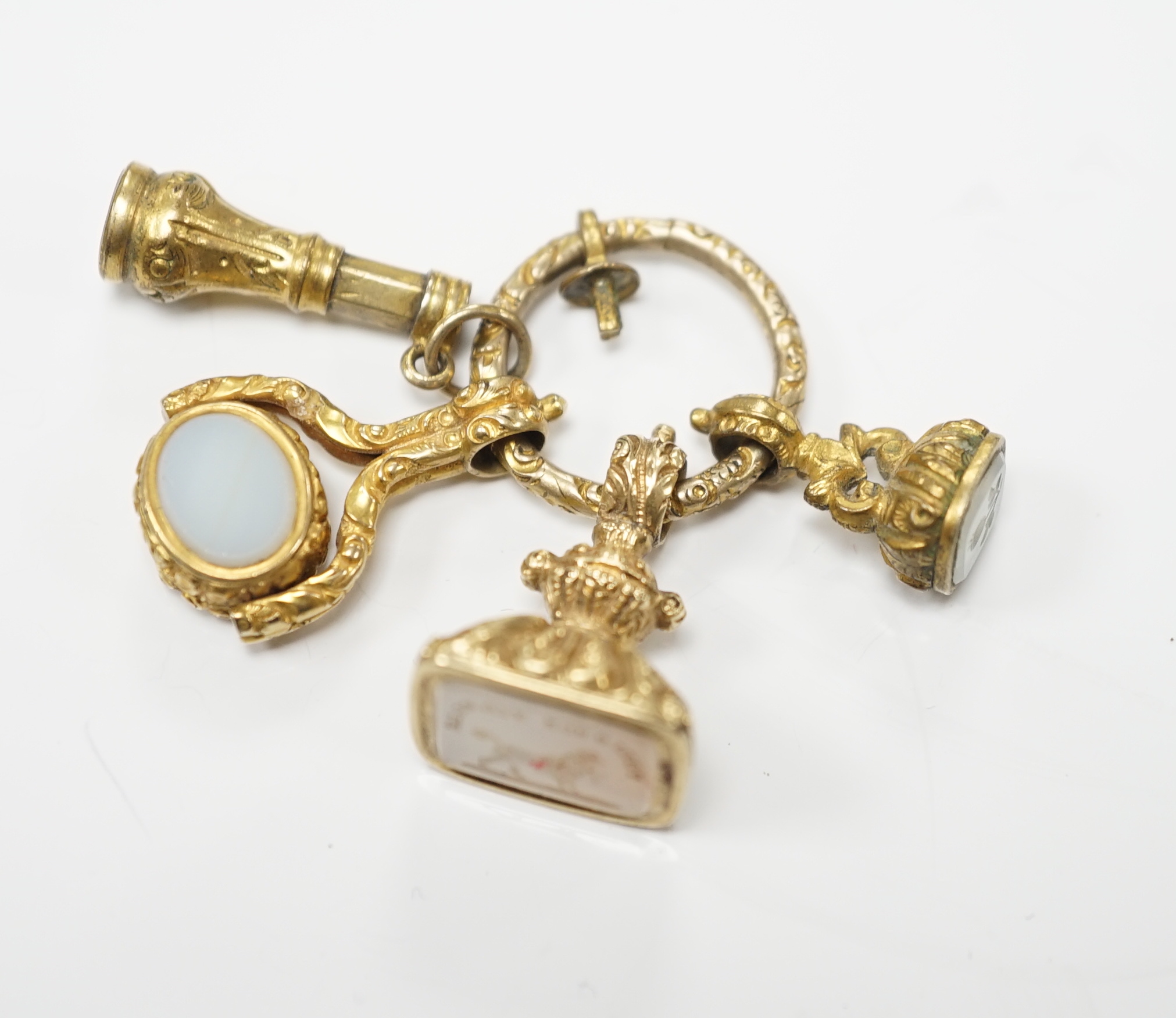 Three assorted 19th century yellow metal overlaid and chalcedony set fob seals and one other item, all mounted on a loop ring, largest approx. 20mm.